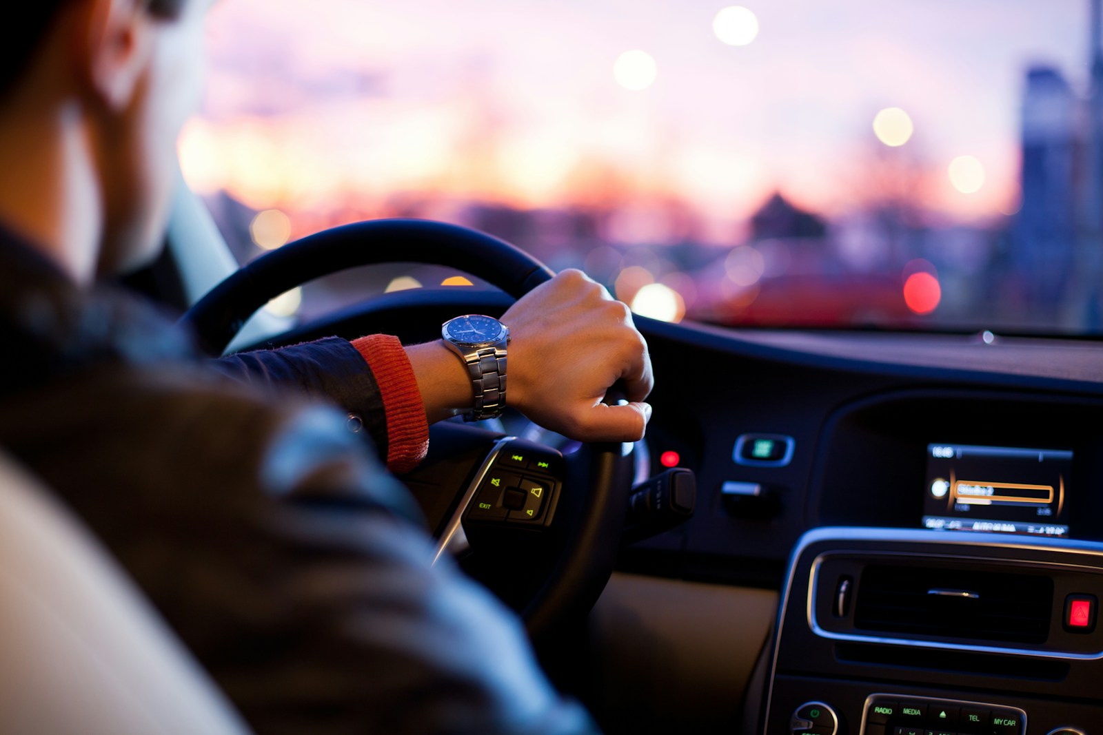 man driving an auto wearing wrist watch